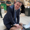 Mel Stride in Parliament receiving CPR training from the London Ambulance Service